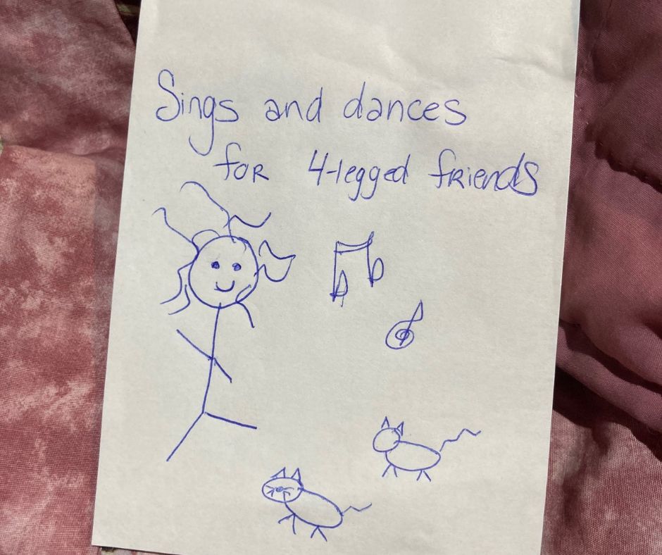 notebook with a doodle in pen and the words, sings and dances for 4-legged friends