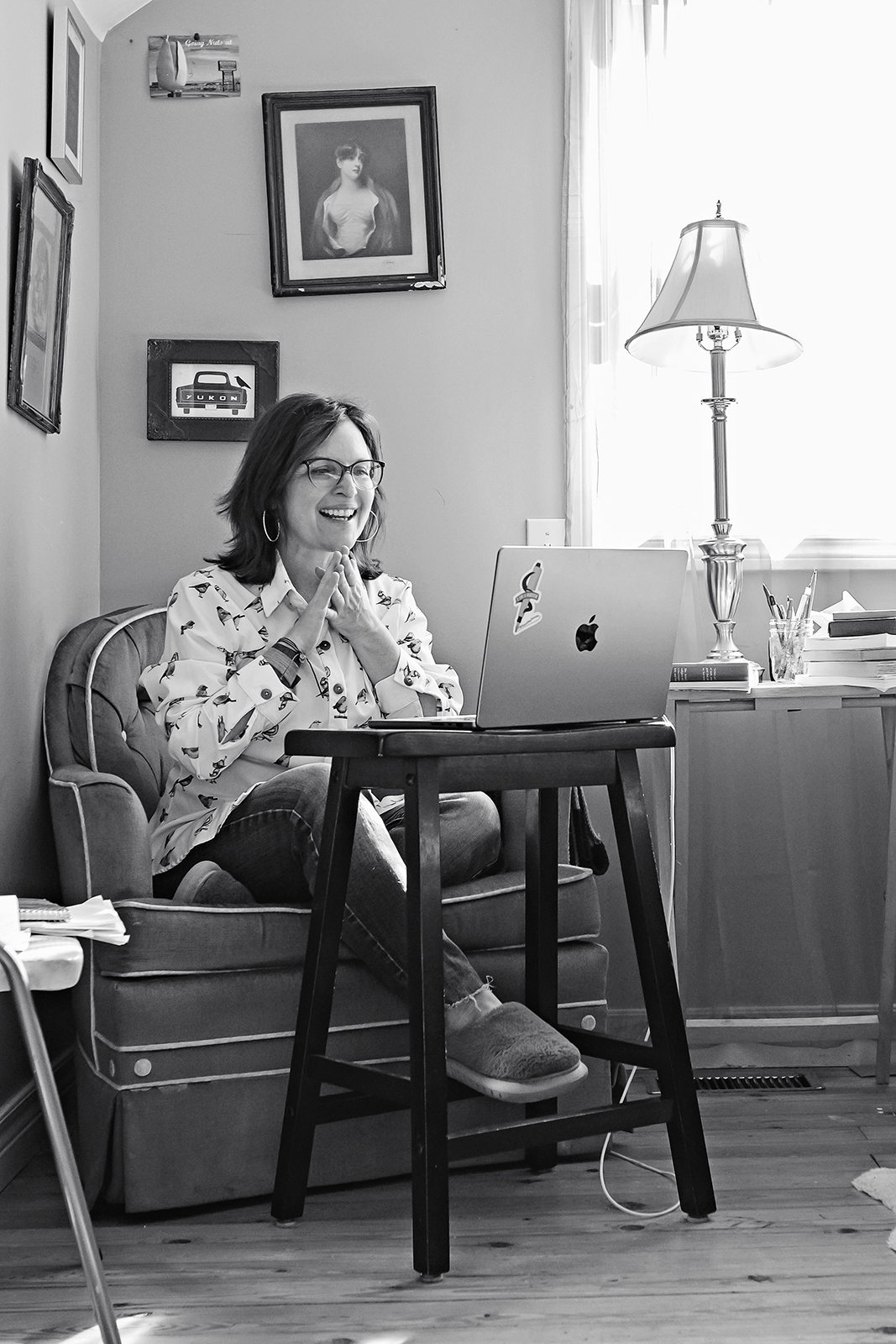 Author Erica Richmond leads a virtual writing mentorship session at a small desk in her bright home office.